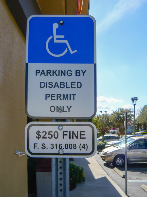 Warning sign at a disabled bay warning that only permit holders can use it.