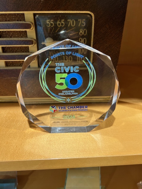 Urban One Philadelphia is awarded the Civic 50 Award accepted by Ezio Torres, Sean Sams, and Anthony Sellers