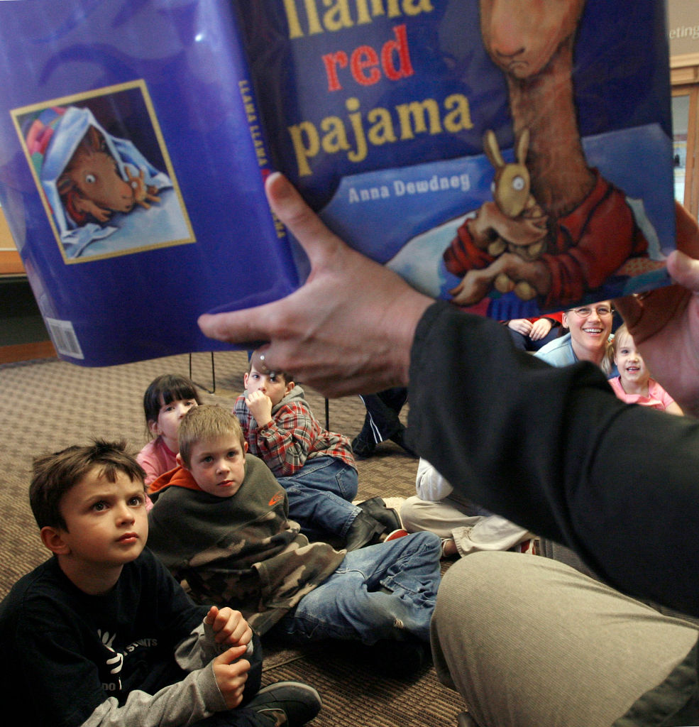 nolibrary_074_mac.jpg (kids front to back)- Colin Lee, Nick Needham, Harlie Latham, Wyatt Latham and Hannah Joseph (far right w/ her mom). Branch Supervisor Lori Hettman, reads" llama llama red pajama" book to the children. Weekly "Storytime" brings re