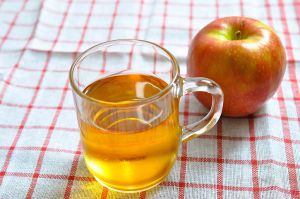 Close-up of apple and drink on table
