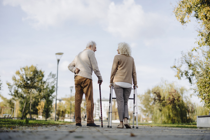 Elderly Couple Enjoys a Leisurely Walk in the Park
