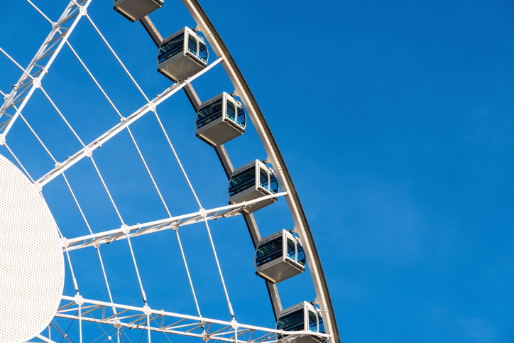 Closeup part of ferris wheel over the blur sky