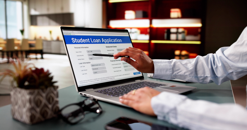 Person Hand Over Student Loan Application