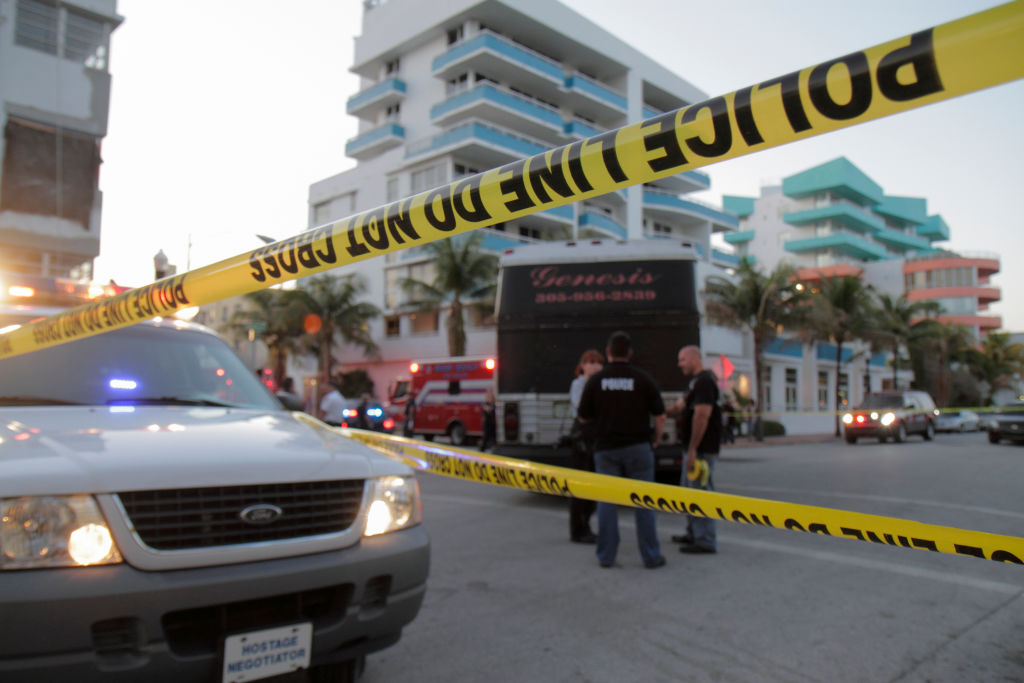 Police line do not cross tape at a collision site on Ocean Drive.