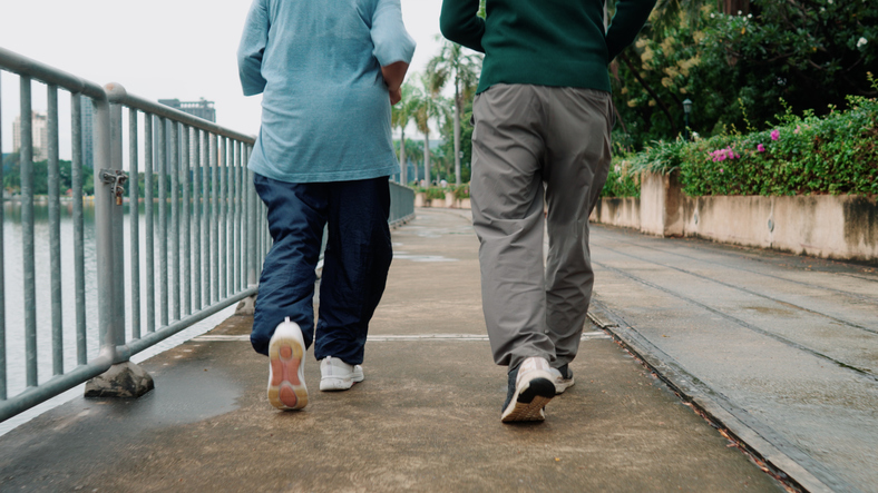 Senior couple enjoys running together in the park, staying active and healthy